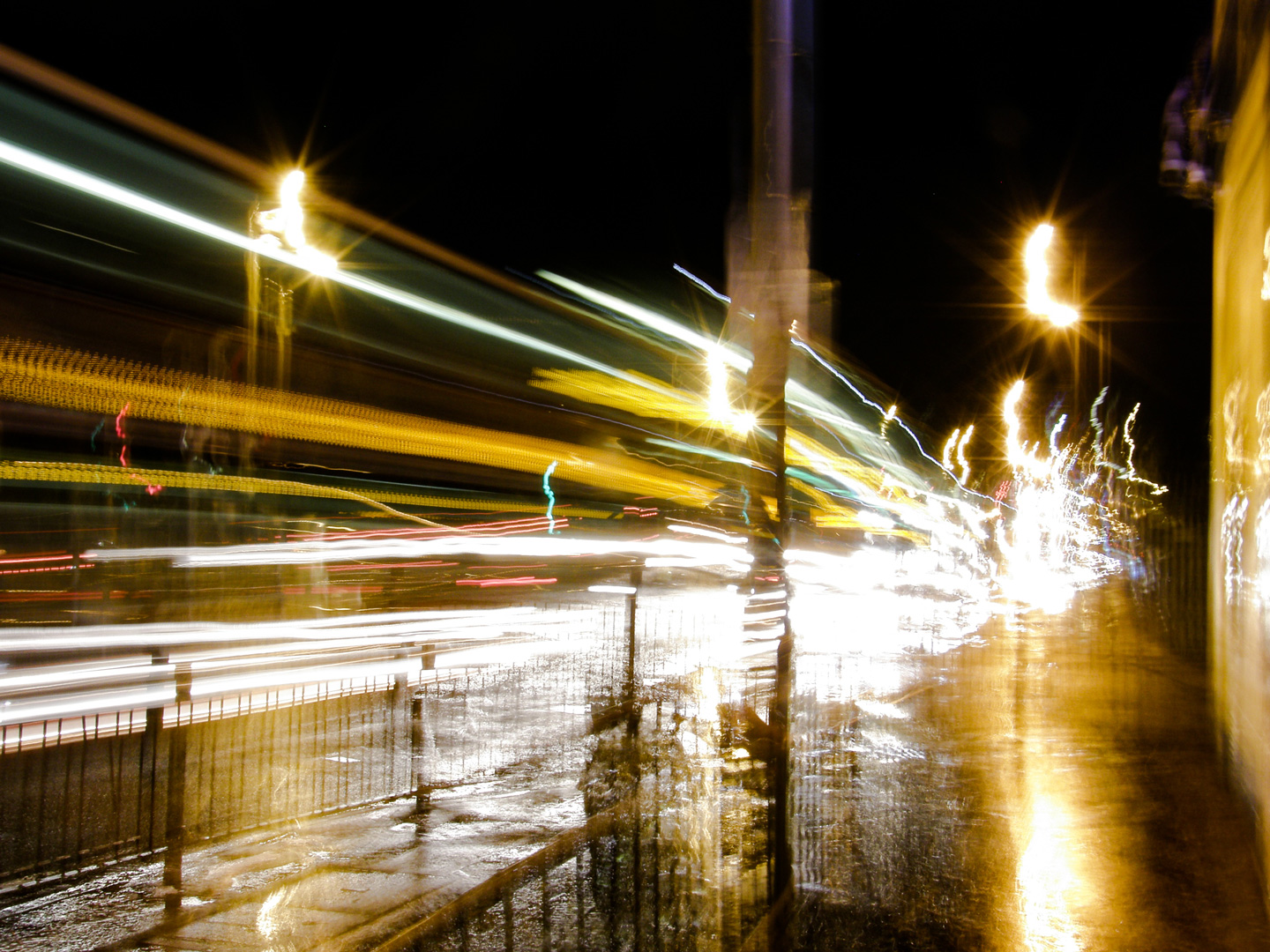 Long-exposure photo of city street lights at night, creating colorful light trails.